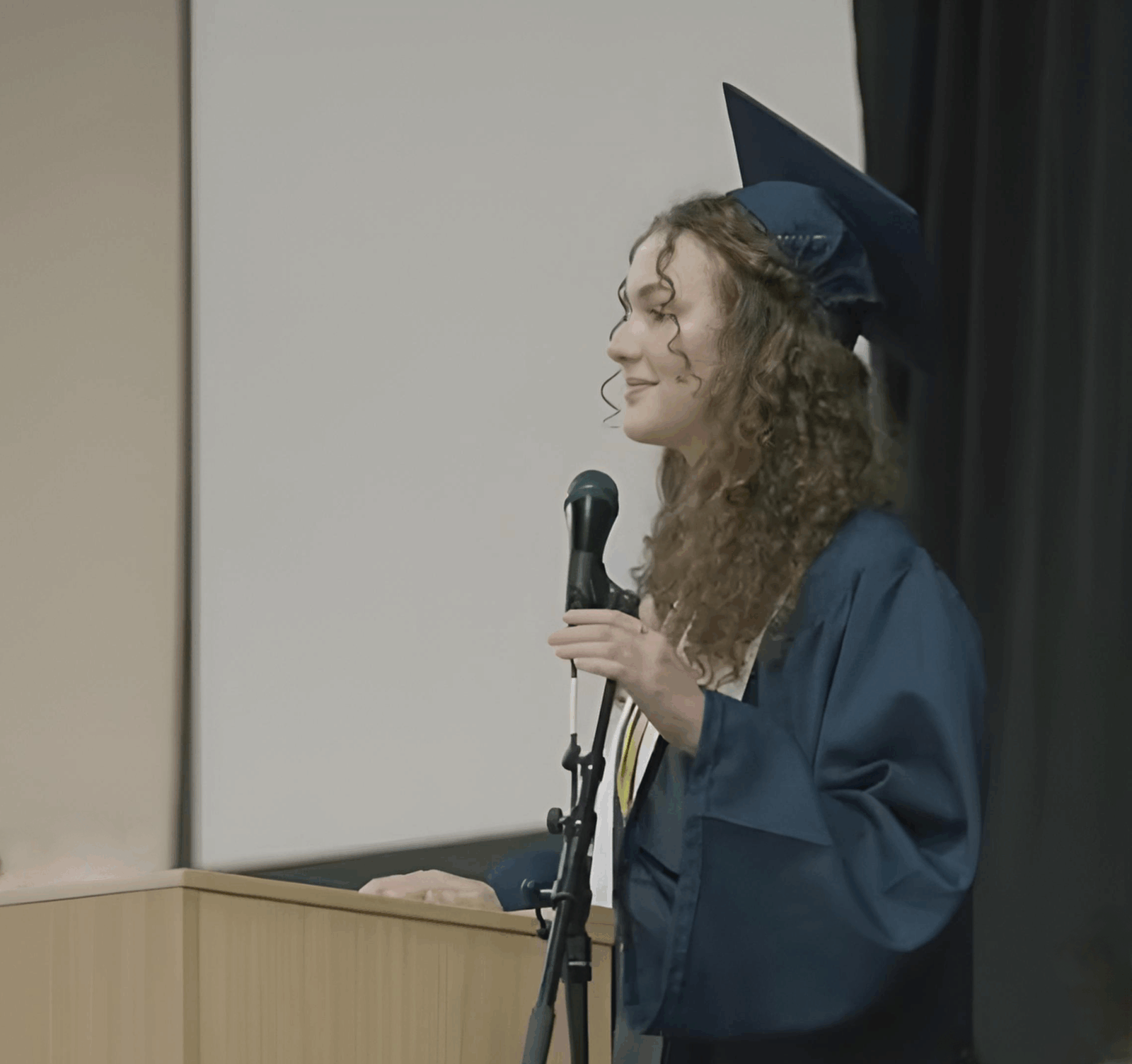 Honor Hawkes, Wilson Hill Academy’s 2025 valedictorian, delivering her commencement address at the podium in cap and gown